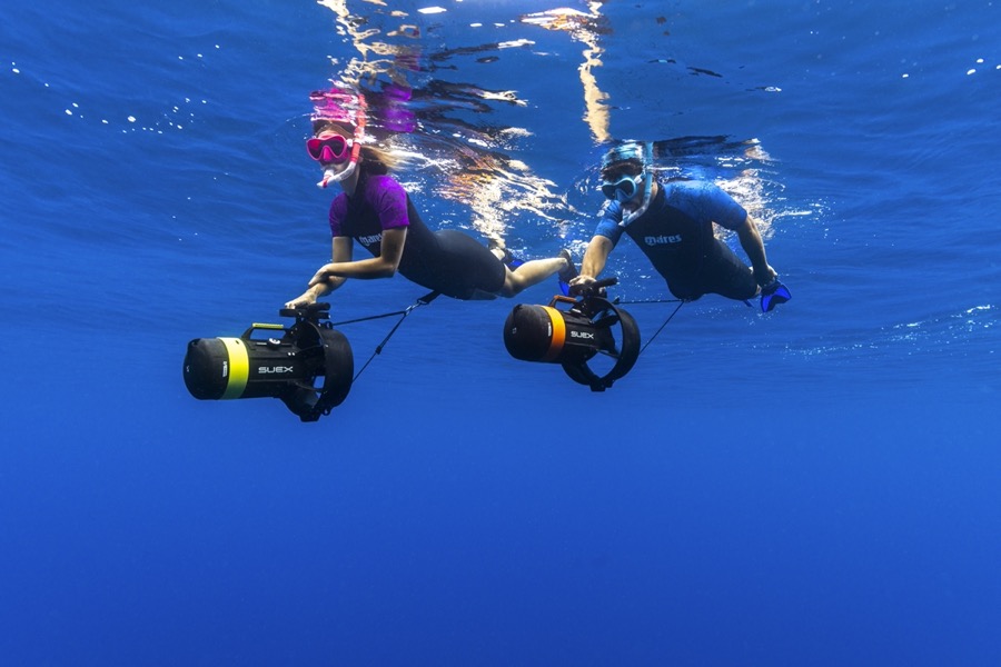 Two participants side by side with DPV scooters